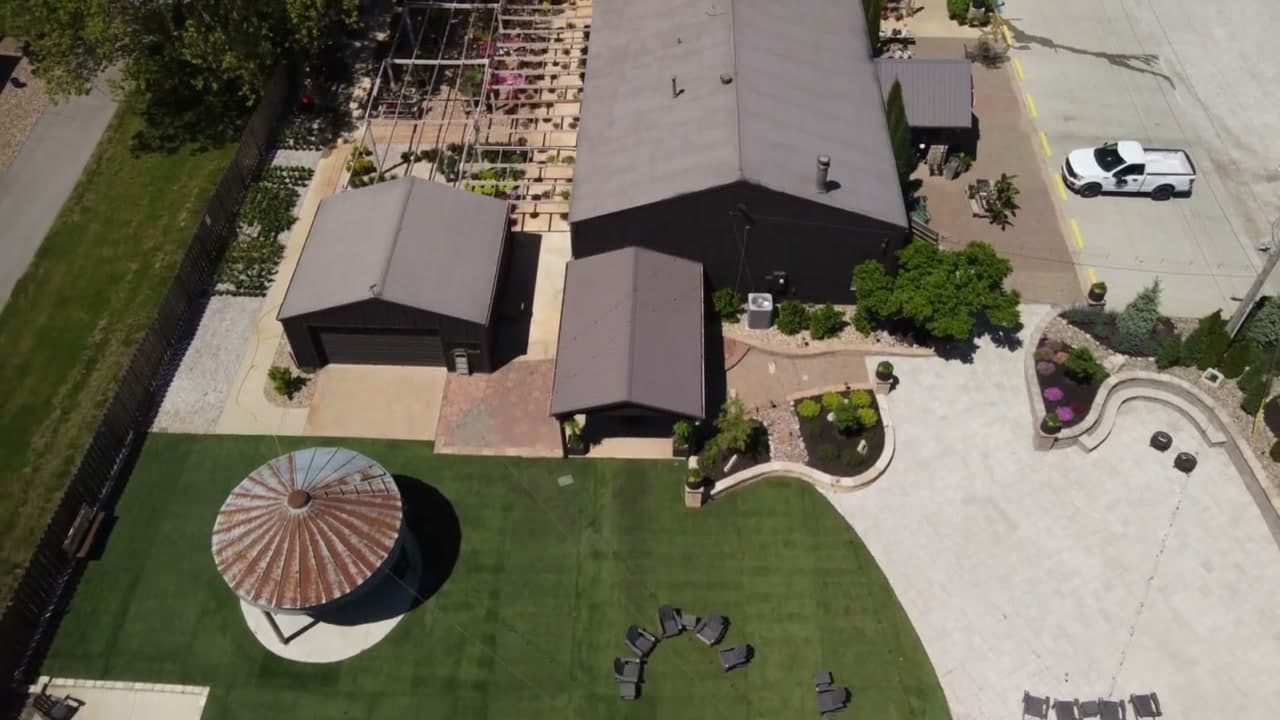 Aerial view of venue buildings, gazebo, and fire pit seating area