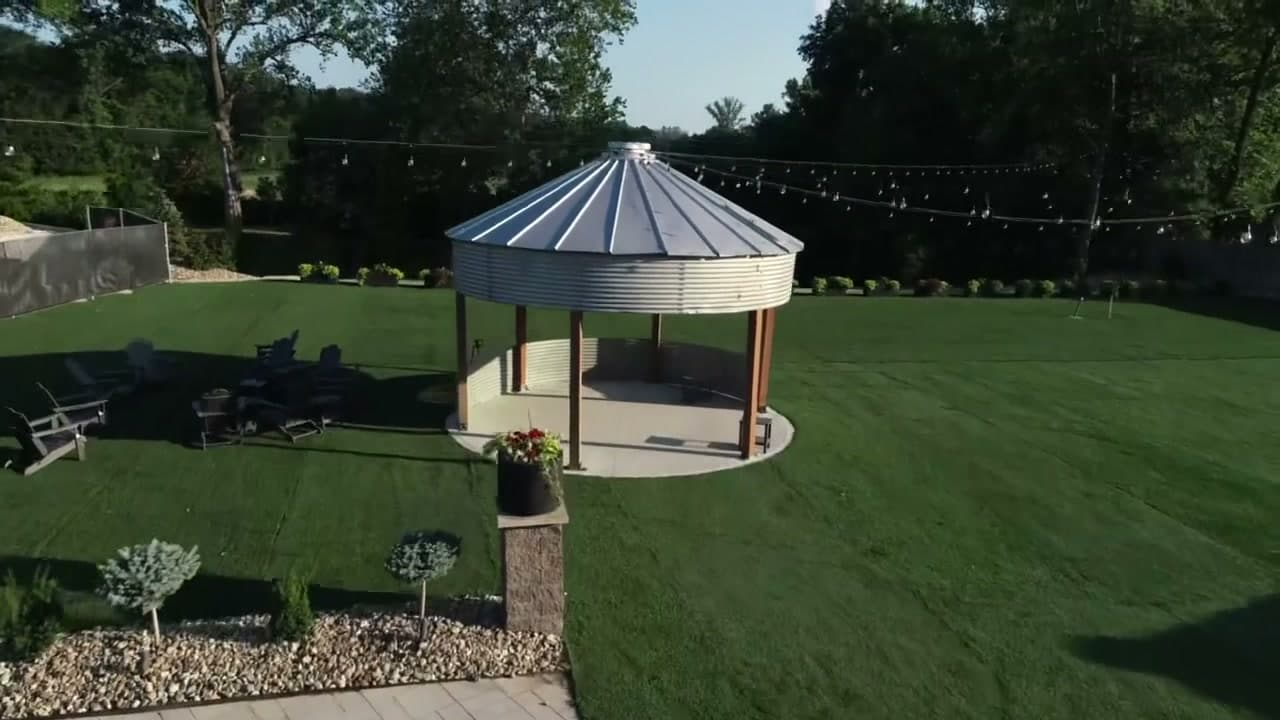 Grain bin gazebo with string lights at golden hour