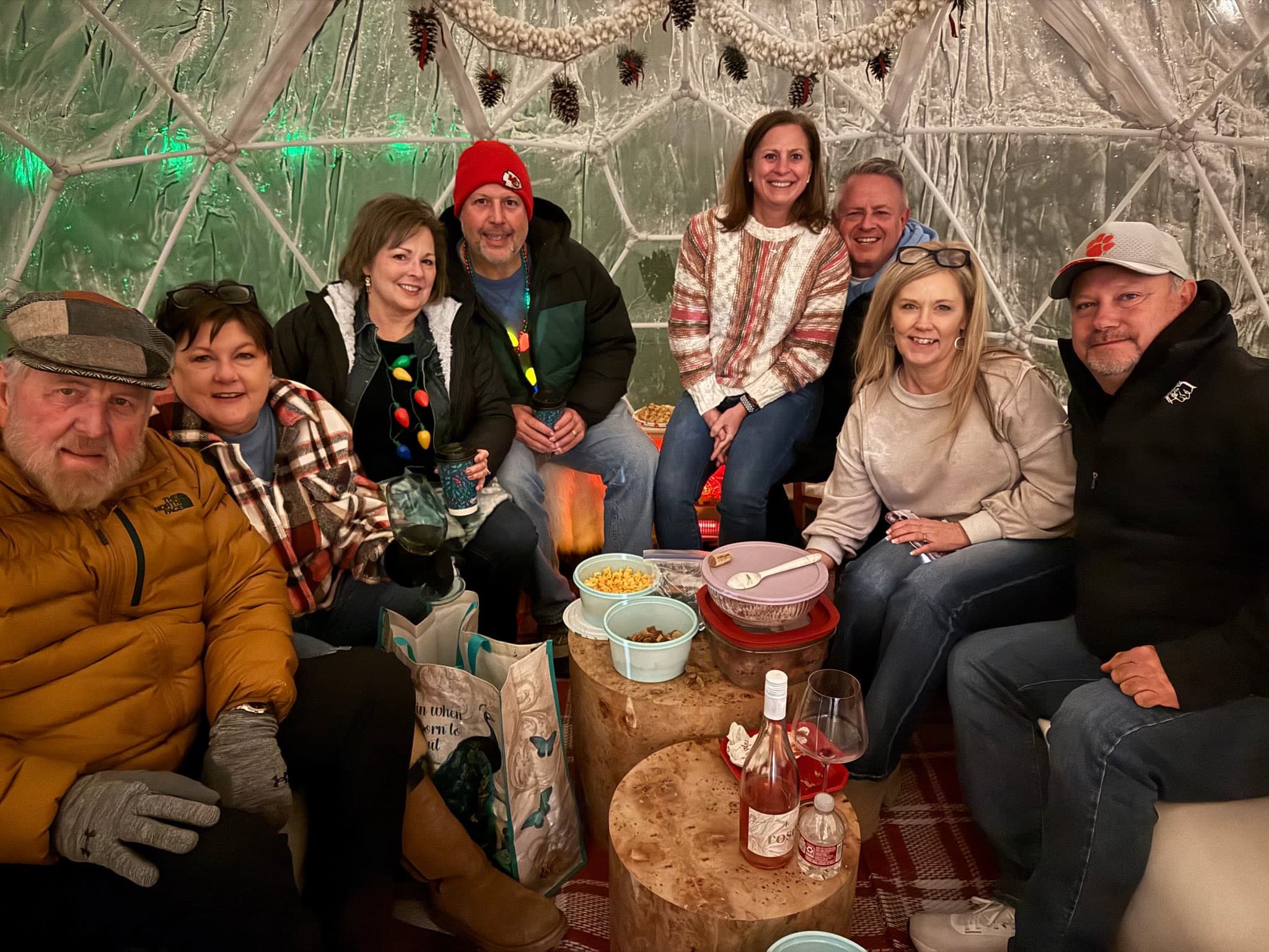Guests gathered inside a heated igloo dome for a winter celebration