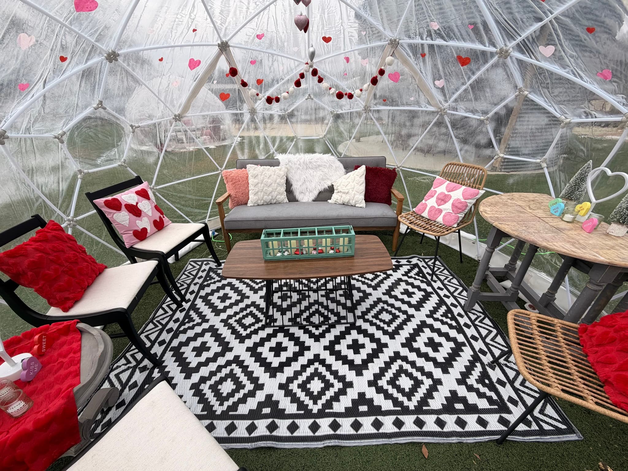 Cozy igloo dome interior with eclectic lounge furniture and festive decor